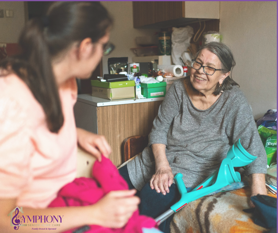 Caregiver sitting with an older adult at home, offering in-home care support and companionship to help with daily needs.