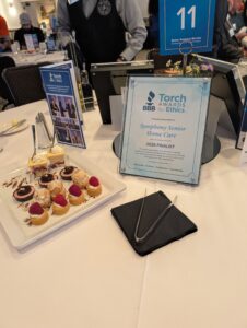 BBB Torch Award Finalist plaque for Symphony Senior Home Care displayed at event table